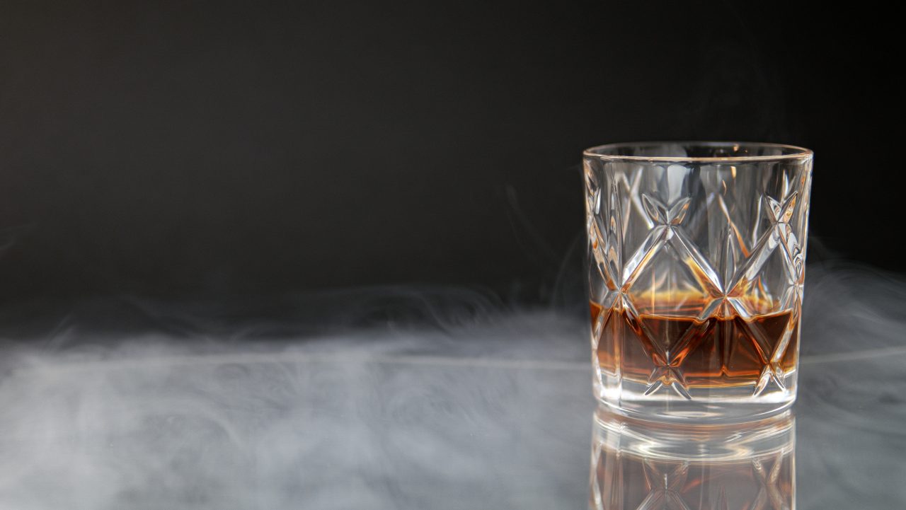 glass-whiskey-table-surrounded-by-smoke-against-black-background-1280x721.jpg